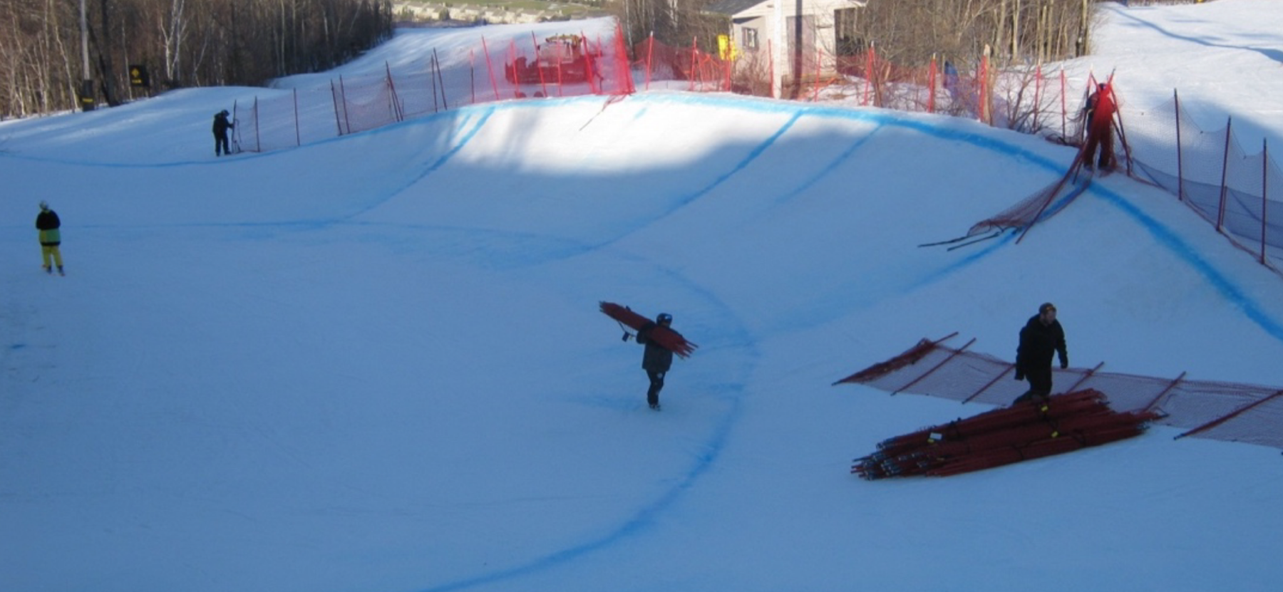 Officials and volunteers preparing the snowboard cross course at Crabbe Mountain